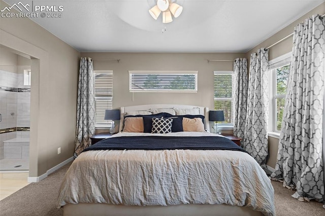 1734 Summerglow Ln, Monument, CO 80132 - carpeted bedroom with ensuite bathroom, baseboards, and ceiling fan