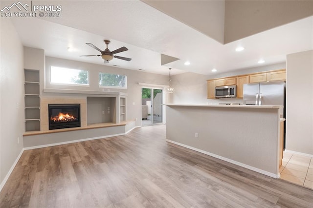 3867 Josephine Hts, Colorado Springs, CO 80906 - unfurnished living room with ceiling fan, light wood-type flooring, recessed lighting, and a tile fireplace