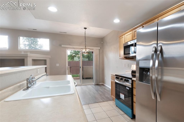 3867 Josephine Hts, Colorado Springs, CO 80906 - kitchen featuring stainless steel appliances, light tile patterned floors, light countertops, recessed lighting, and pendant lighting