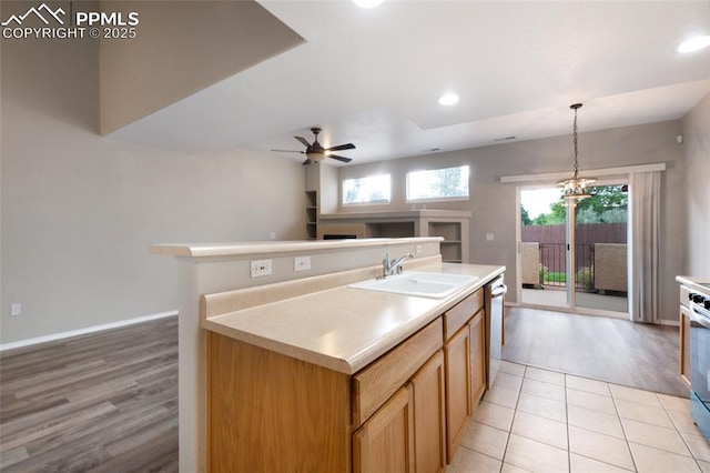 3867 Josephine Hts, Colorado Springs, CO 80906 - kitchen featuring open floor plan, stainless steel appliances, a ceiling fan, light countertops, and a kitchen island with sink