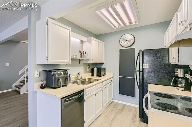 4652 Excalibur Ct, Colorado Springs, CO 80917 - kitchen with dishwasher, light wood-style floors, white range with electric stovetop, white cabinets, and black microwave