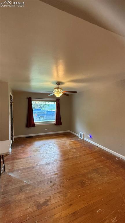 5030 Beach Ct, Denver, CO 80221 - unfurnished room featuring hardwood / wood-style floors, baseboards, and ceiling fan