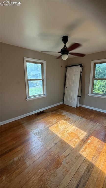 5030 Beach Ct, Denver, CO 80221 - unfurnished bedroom featuring baseboards, light wood-type flooring, and a ceiling fan