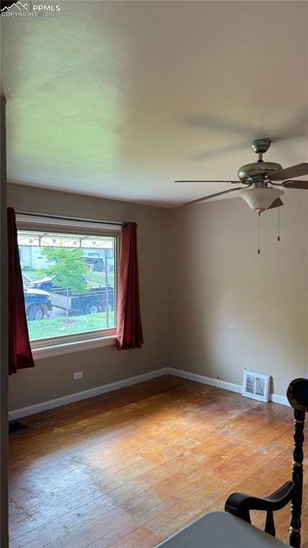 5030 Beach Ct, Denver, CO 80221 - unfurnished room with wood-type flooring, ceiling fan, and baseboards