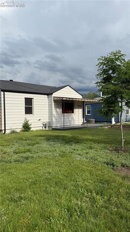 5030 Beach Ct, Denver, CO 80221 - back of house with a lawn