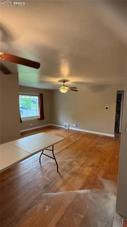 5030 Beach Ct, Denver, CO 80221 - unfurnished living room with ceiling fan, hardwood / wood-style floors, and baseboards