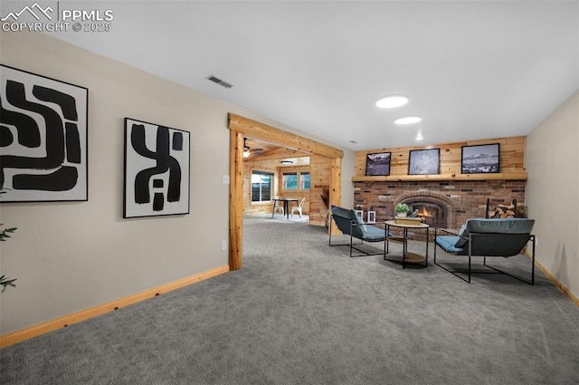 3512 Chico Cir, Colorado Springs, CO 80918 - sitting room featuring wood walls, carpet, and a fireplace