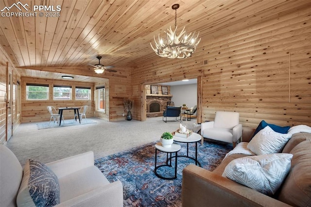 3512 Chico Cir, Colorado Springs, CO 80918 - carpeted living room with wooden ceiling, a chandelier, ceiling fan, rustic walls, and a stone fireplace