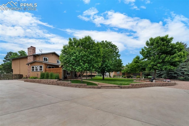 3512 Chico Cir, Colorado Springs, CO 80918 - view of front of property with a chimney, driveway, and stucco siding