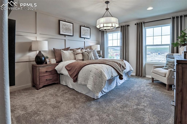 7703 Lost Trail Dr, Colorado Springs, CO 80908 - bedroom featuring baseboards, carpet floors, recessed lighting, and a chandelier