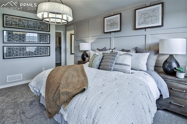 7703 Lost Trail Dr, Colorado Springs, CO 80908 - carpeted bedroom with a decorative wall, a chandelier, and baseboards