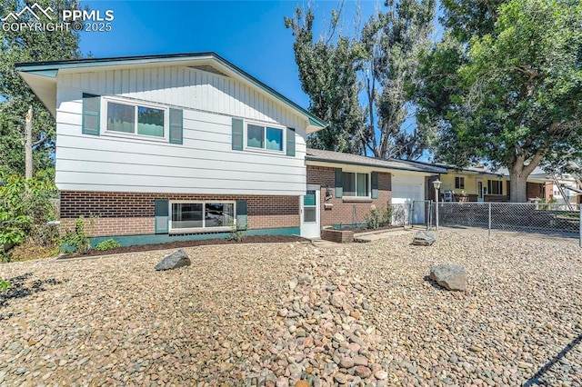 3622 Anemone Cir, Colorado Springs, CO 80918 - split level home featuring an attached garage and brick siding