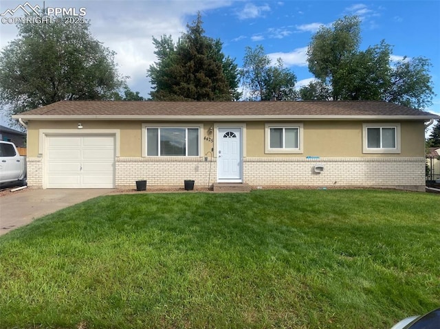 4425 Barkman Cir, Colorado Springs, CO 80916 - single story home with brick siding, a front yard, a garage, driveway, and stucco siding