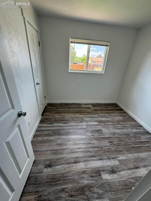 4425 Barkman Cir, Colorado Springs, CO 80916 - unfurnished bedroom featuring wood finished floors and baseboards