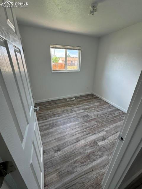 4425 Barkman Cir, Colorado Springs, CO 80916 - unfurnished bedroom featuring wood finished floors and baseboards