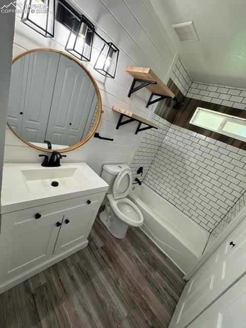 4425 Barkman Cir, Colorado Springs, CO 80916 - bathroom featuring vanity, toilet, wood finished floors, and shower / tub combination