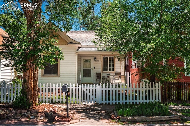 2830 W Kiowa St, Colorado Springs, CO 80904 - view of front of property with a fenced front yard and roof with shingles