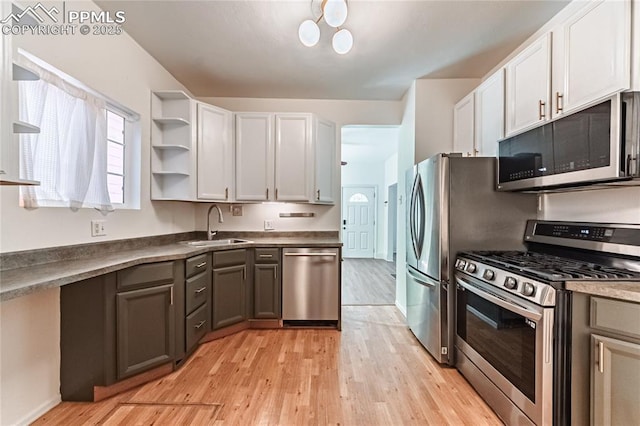 2830 W Kiowa St, Colorado Springs, CO 80904 - kitchen featuring stainless steel appliances, open shelves, light wood-style floors, dark countertops, and white cabinetry