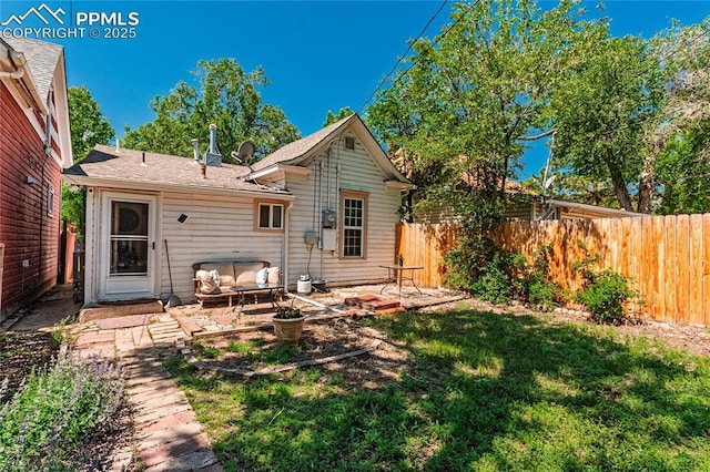 2830 W Kiowa St, Colorado Springs, CO 80904 - rear view of house featuring a fenced backyard, a patio, and outdoor lounge area