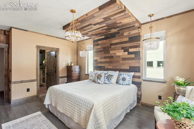 1124 E Poncha Ave, Salida, CO 81201 - bedroom with a chandelier, wood finished floors, and wood walls