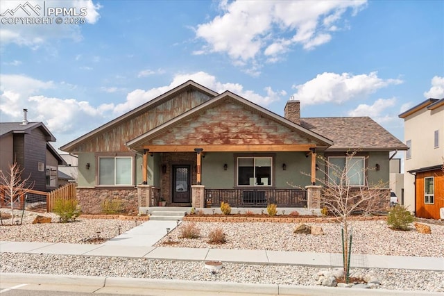 1124 E Poncha Ave, Salida, CO 81201 - view of front of property with covered porch, stucco siding, stone siding, and a chimney