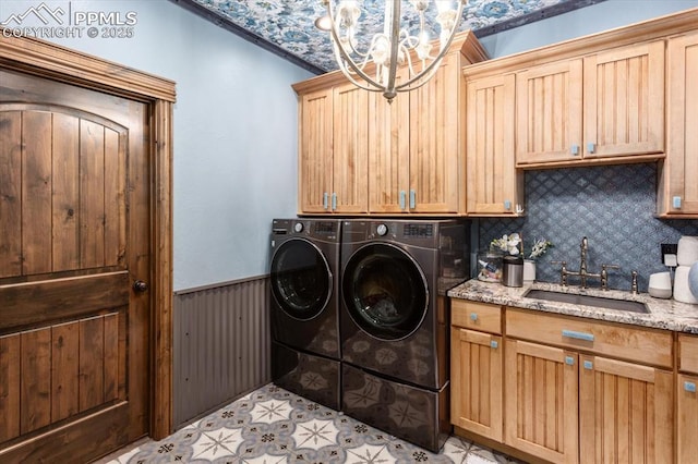 1124 E Poncha Ave, Salida, CO 81201 - washroom with cabinet space, wainscoting, washing machine and clothes dryer, and a chandelier
