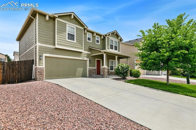 3748 Reindeer Cir, Colorado Springs, CO 80922 - view of front facade with driveway, an attached garage, and stone siding