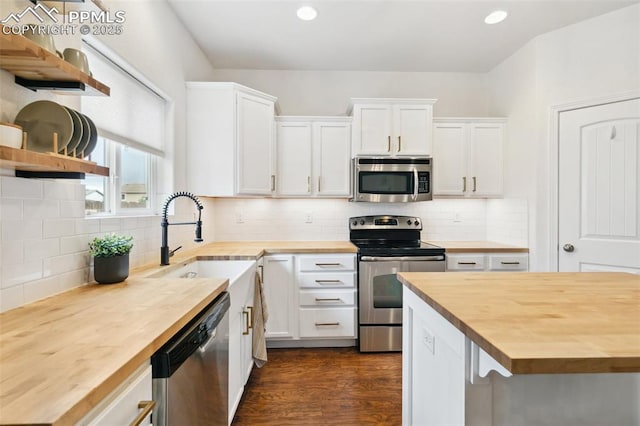 3748 Reindeer Cir, Colorado Springs, CO 80922 - kitchen with butcher block countertops, appliances with stainless steel finishes, open shelves, white cabinetry, and recessed lighting
