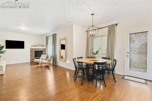3748 Reindeer Cir, Colorado Springs, CO 80922 - dining area featuring a chandelier, wood finished floors, and baseboards