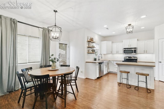 3748 Reindeer Cir, Colorado Springs, CO 80922 - dining space with a chandelier, wood finished floors, recessed lighting, and baseboards