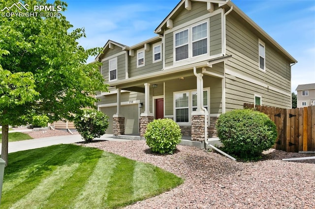 3748 Reindeer Cir, Colorado Springs, CO 80922 - craftsman house featuring a porch, an attached garage, and stone siding