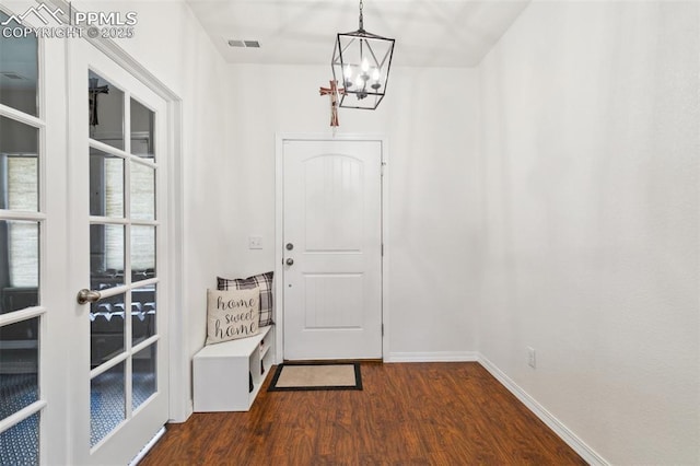 3748 Reindeer Cir, Colorado Springs, CO 80922 - doorway to outside featuring dark wood finished floors, a chandelier, and baseboards