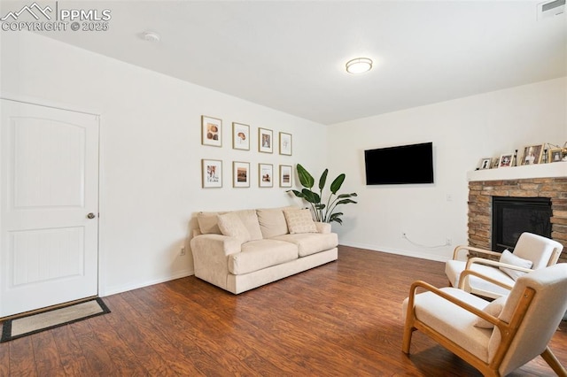 3748 Reindeer Cir, Colorado Springs, CO 80922 - living room with dark wood-style floors, baseboards, and a fireplace