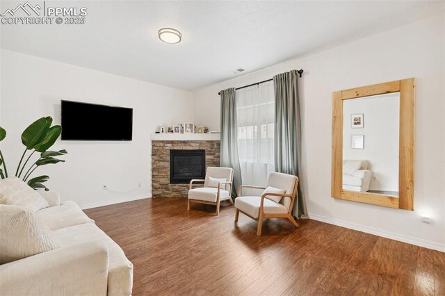 3748 Reindeer Cir, Colorado Springs, CO 80922 - living area with wood finished floors, baseboards, and a fireplace