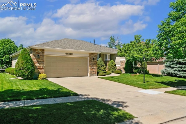 10290 Peach Blossom Trl, Colorado Springs, CO 80920 - ranch-style home featuring brick siding, a garage, driveway, and a front yard