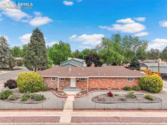 2043 Patrician Way, Colorado Springs, CO 80909 - ranch-style house featuring a chimney and stone siding