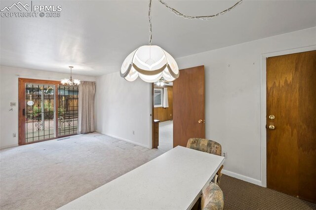 2043 Patrician Way, Colorado Springs, CO 80909 - carpeted dining space with a chandelier and baseboards