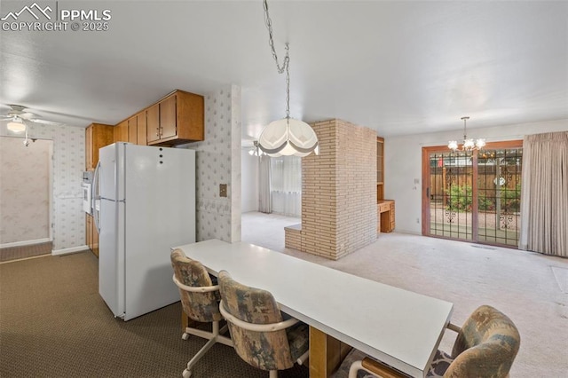 2043 Patrician Way, Colorado Springs, CO 80909 - kitchen featuring white appliances, carpet flooring, a chandelier, ceiling fan, and hanging light fixtures