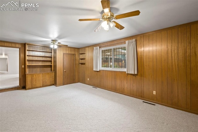 2043 Patrician Way, Colorado Springs, CO 80909 - unfurnished room with ceiling fan, wood walls, carpet, and built in features