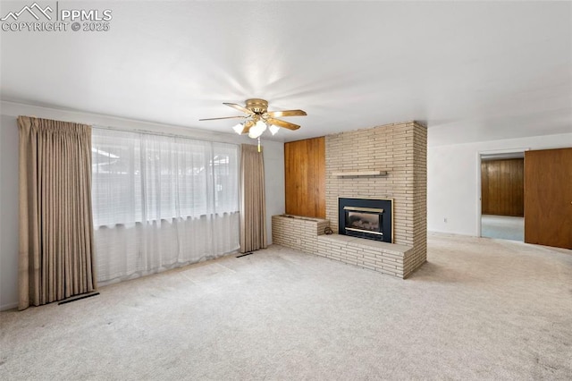 2043 Patrician Way, Colorado Springs, CO 80909 - unfurnished living room with ceiling fan, carpet, and a brick fireplace