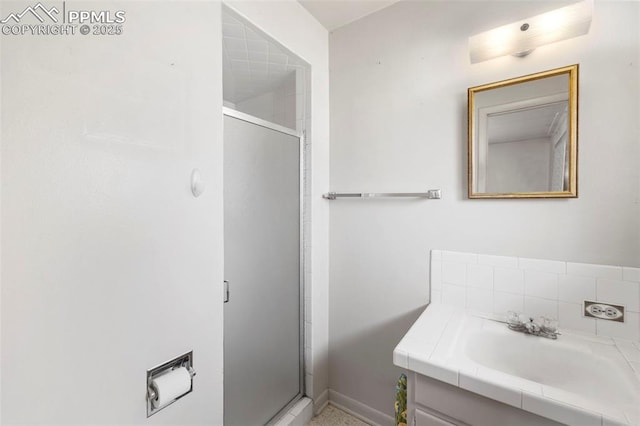 2043 Patrician Way, Colorado Springs, CO 80909 - full bathroom featuring vanity, a stall shower, and baseboards