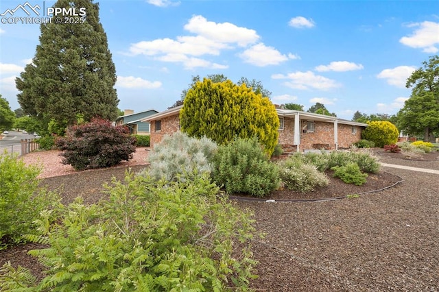 2043 Patrician Way, Colorado Springs, CO 80909 - view of side of home with brick siding