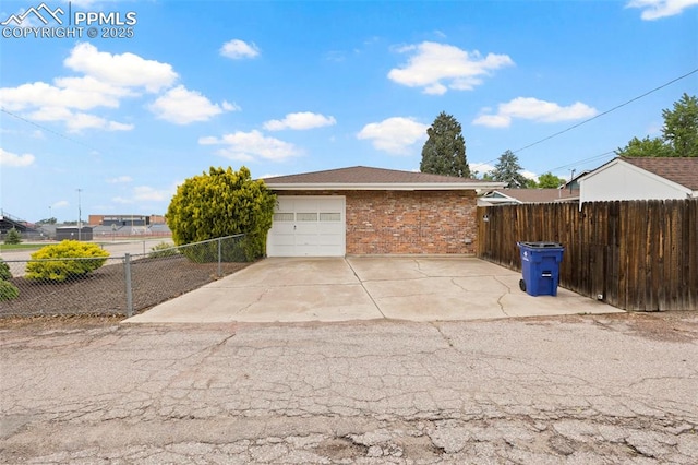 2043 Patrician Way, Colorado Springs, CO 80909 - garage featuring concrete driveway