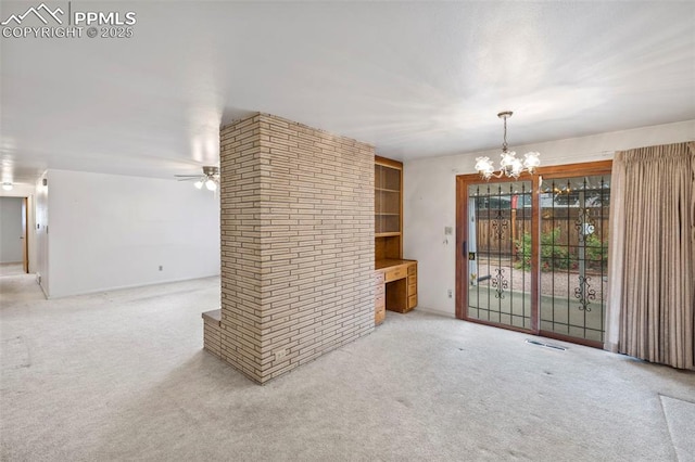 2043 Patrician Way, Colorado Springs, CO 80909 - unfurnished dining area with a chandelier, a ceiling fan, carpet, and built in shelves
