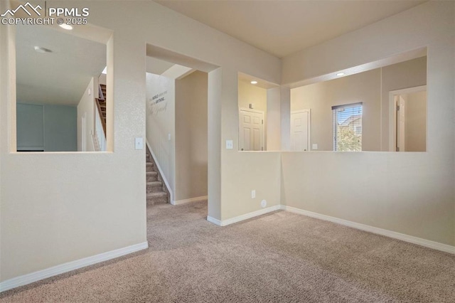 2305 Reed Grass Way, Colorado Springs, CO 80915 - empty room featuring carpet floors, stairway, and baseboards