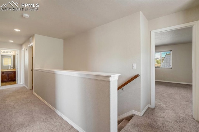 2305 Reed Grass Way, Colorado Springs, CO 80915 - hallway with an upstairs landing, carpet flooring, baseboards, and recessed lighting