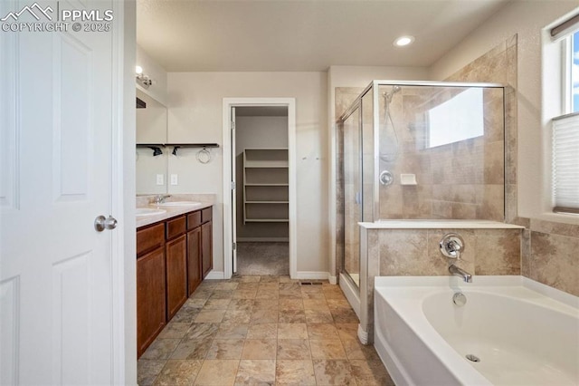2305 Reed Grass Way, Colorado Springs, CO 80915 - bathroom featuring a stall shower, a bath, vanity, recessed lighting, and a spacious closet