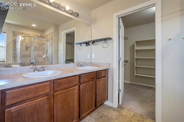 2305 Reed Grass Way, Colorado Springs, CO 80915 - bathroom with a spacious closet, double vanity, and a stall shower