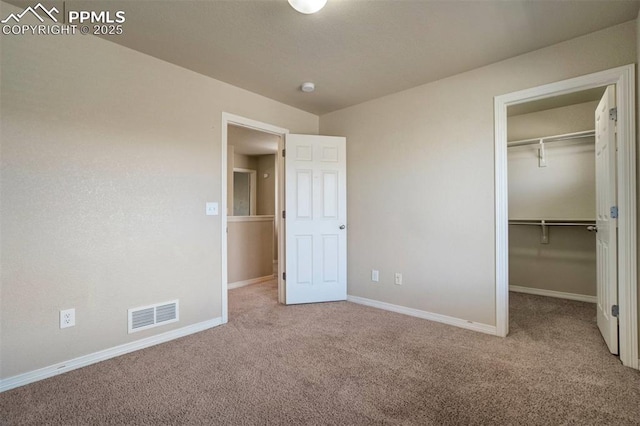 2305 Reed Grass Way, Colorado Springs, CO 80915 - unfurnished bedroom featuring carpet, baseboards, a spacious closet, and a closet