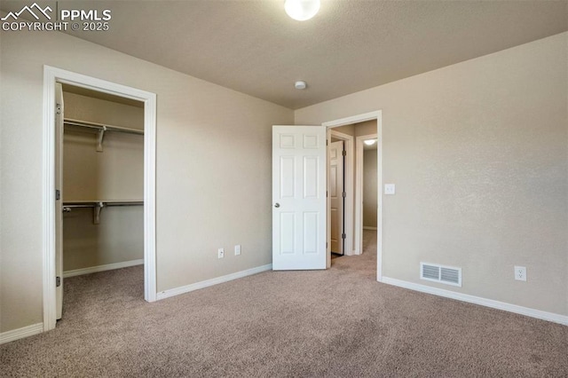 2305 Reed Grass Way, Colorado Springs, CO 80915 - unfurnished bedroom featuring carpet, a spacious closet, and baseboards